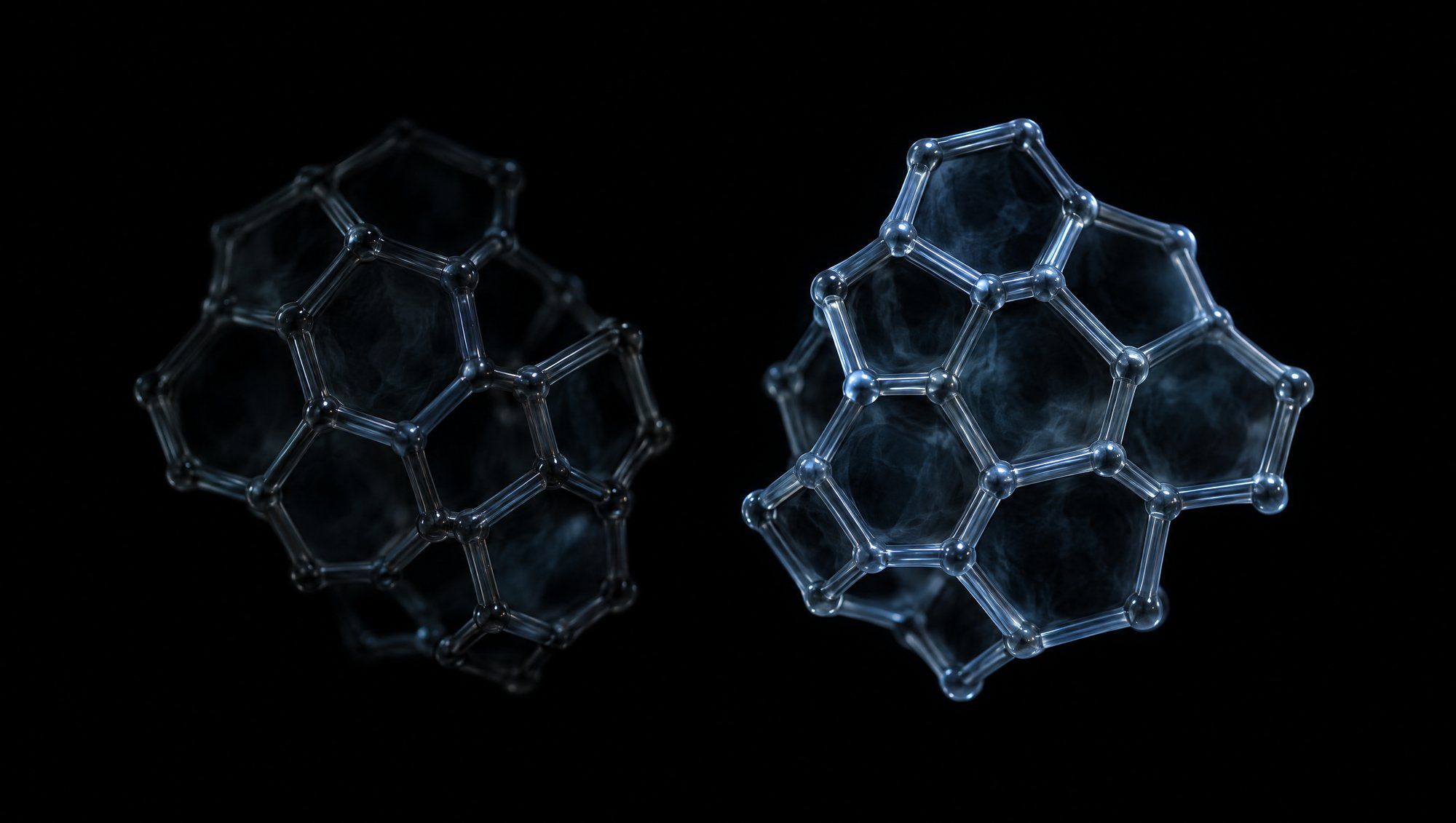 Two smoky glass molecular models built from joined rings floating side by side against black, the right one brighter and rimmed in slate-blue light.